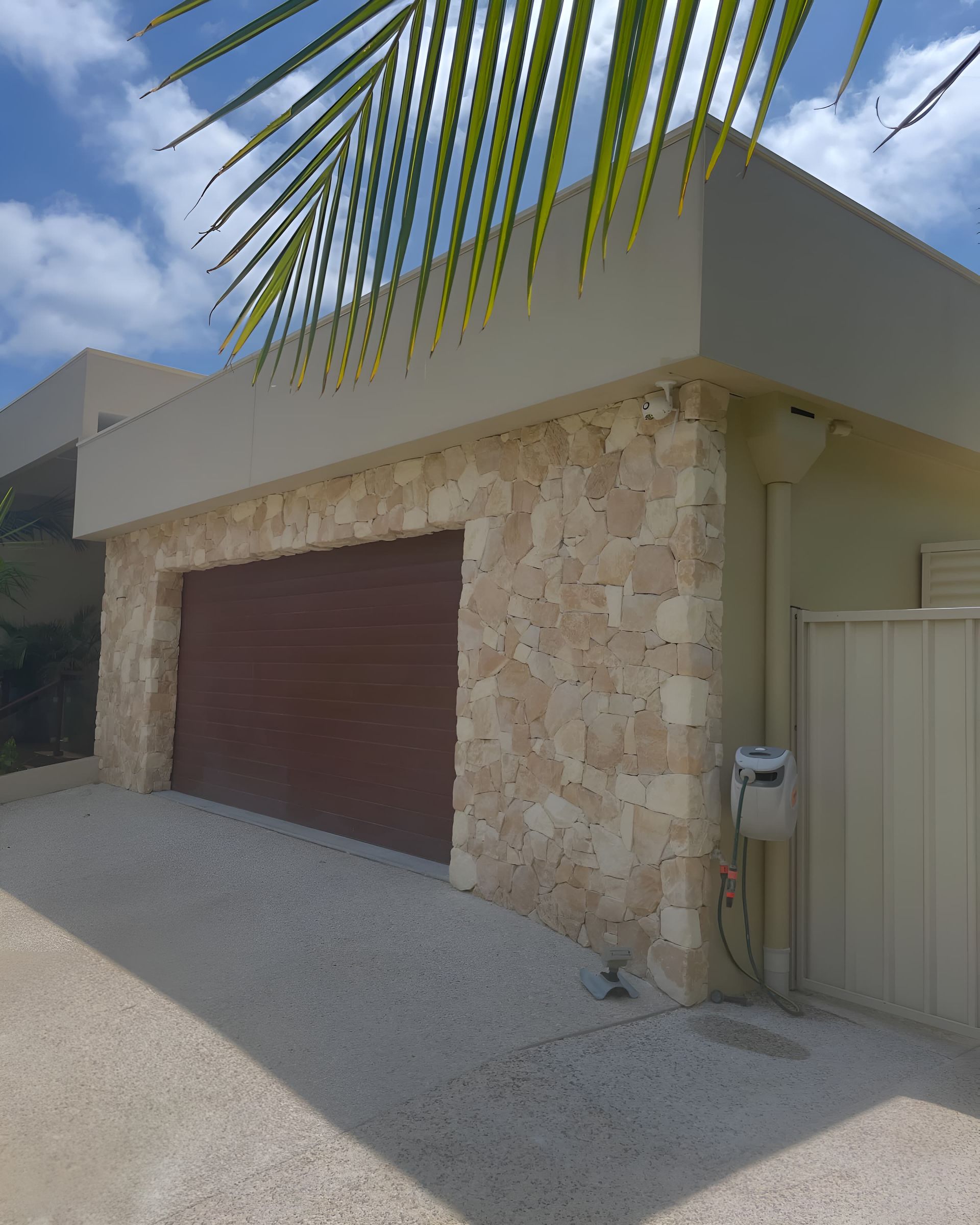 A Brick Wall Is Being Built On The Side Of A Hill — Millers Masonry In Port Macquarie, NSW