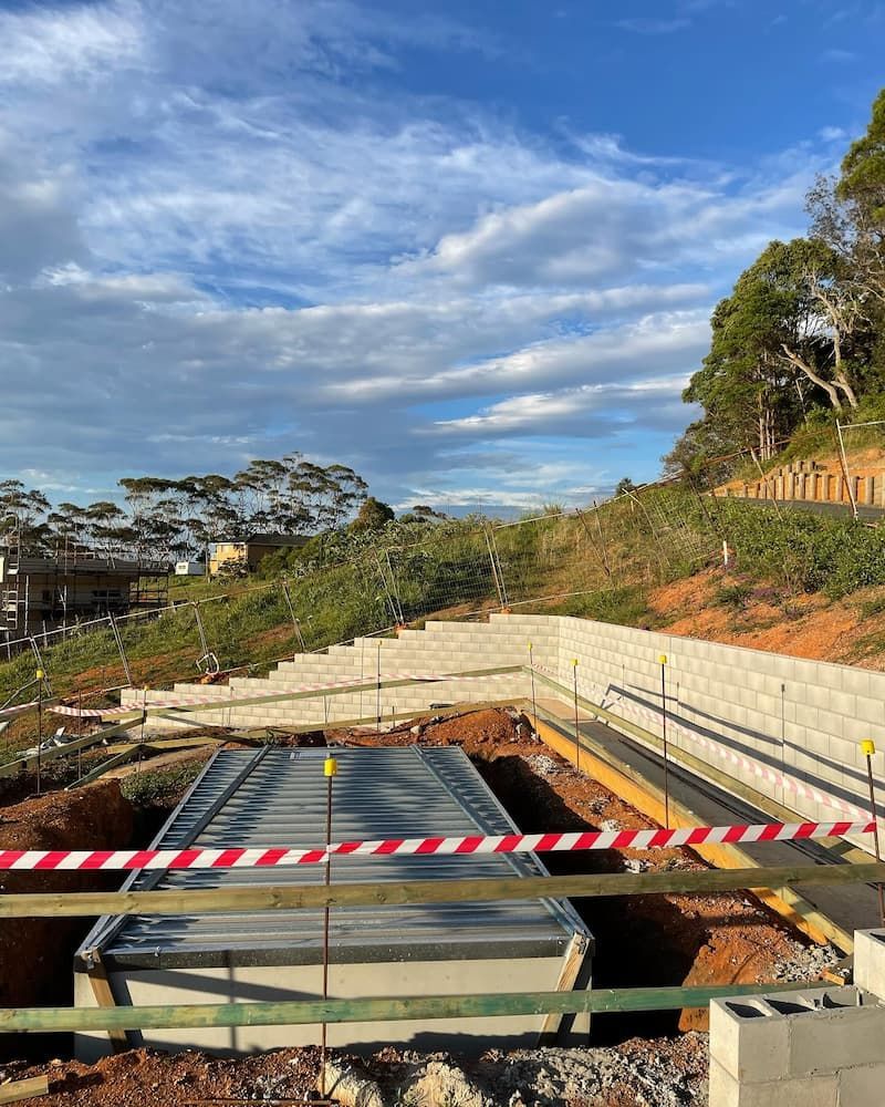 A Large Concrete Structure Is Being Built On Top Of A Dirt Hill — Millers Masonry In Port Macquarie, NSW