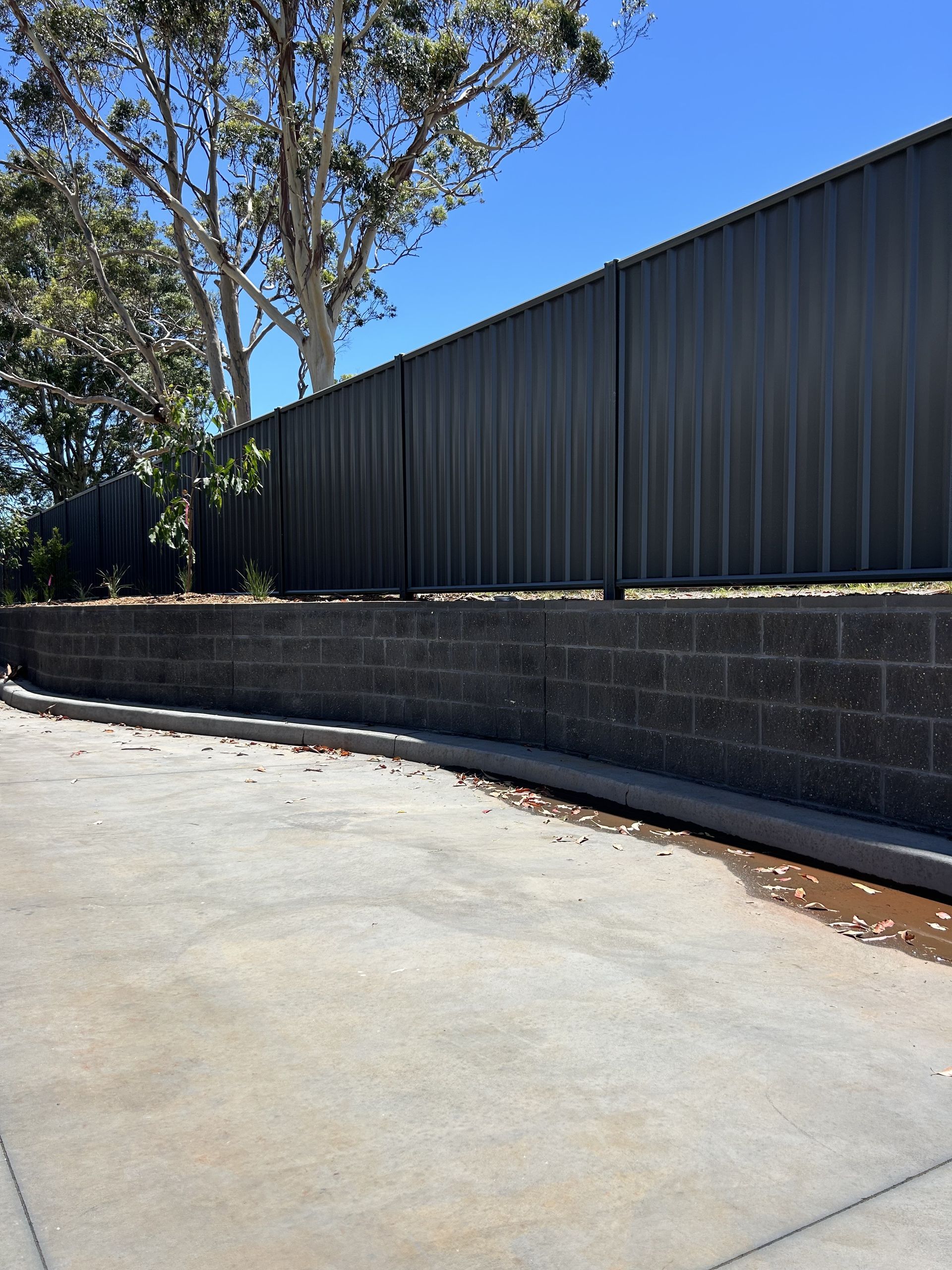 An Excavator Is Digging A Hole In The Dirt In A Field β Millers Masonry In Port Macquarie, NSW