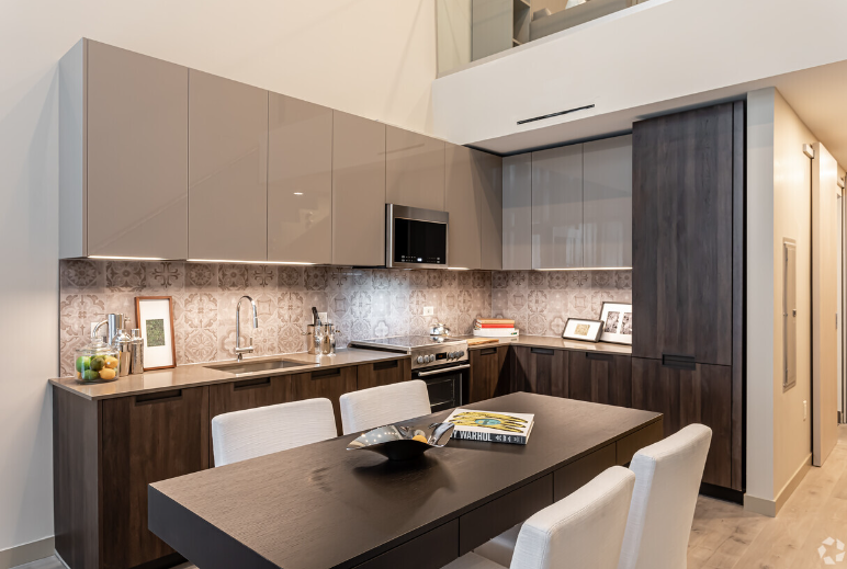 A kitchen and dining room in a house with a table and chairs.