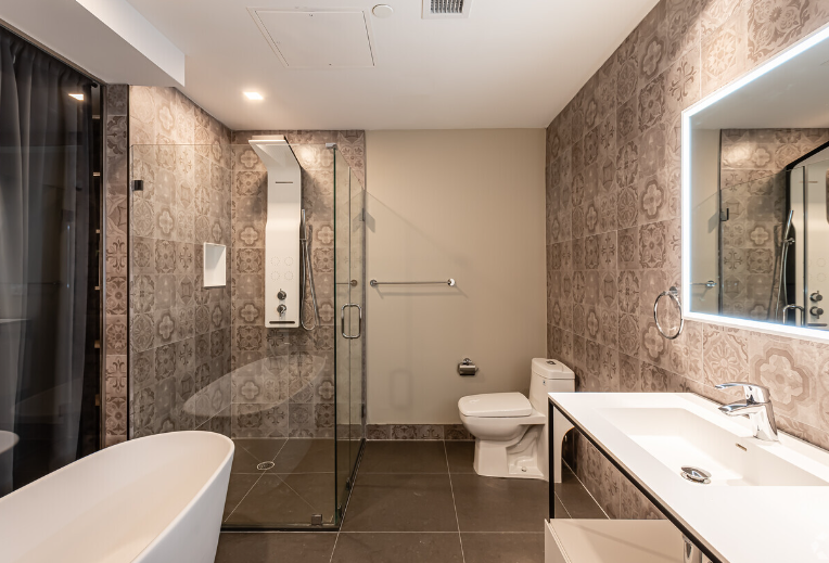 A bathroom with a bathtub , toilet , sink and mirror.