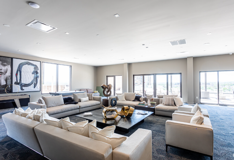 A large living room filled with furniture and a table.