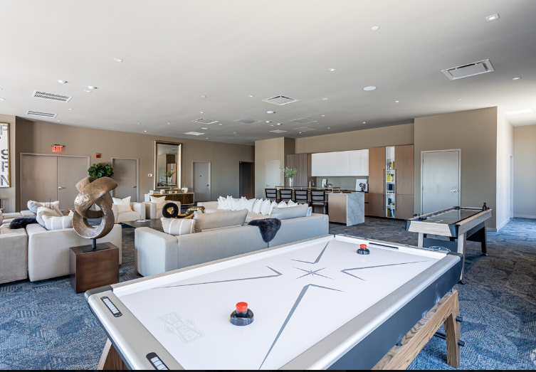 There is a pool table in the middle of the room.