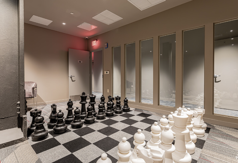 There is a large chess board in the middle of the room.