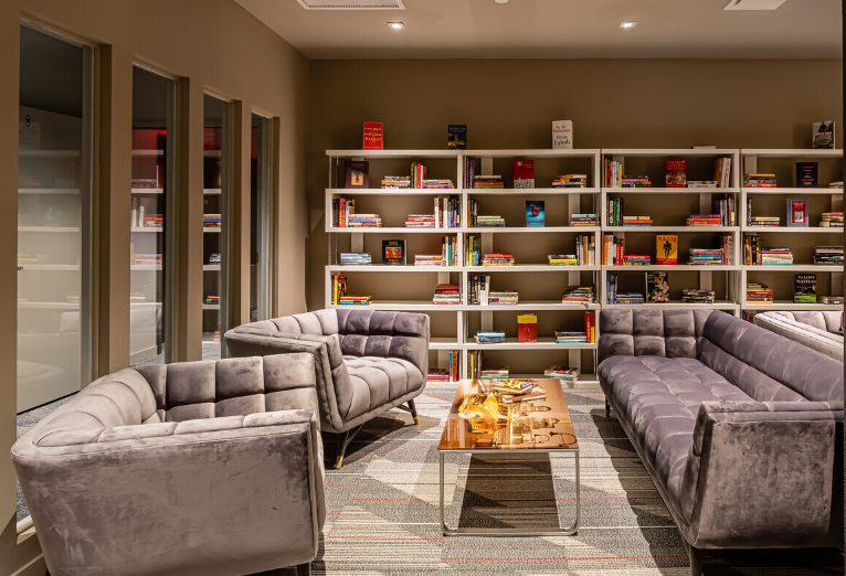 A living room filled with furniture and bookshelves.