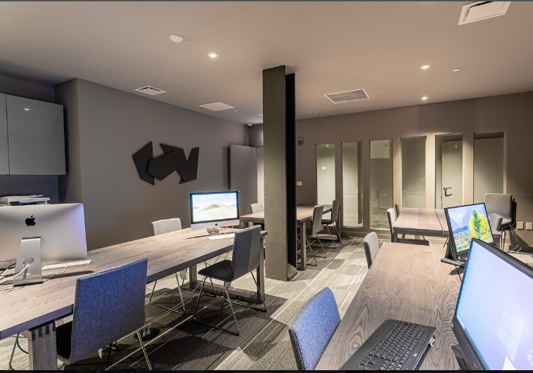 A large room with a lot of computers and chairs