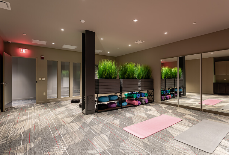 A group of chairs and a fire pit in front of a building