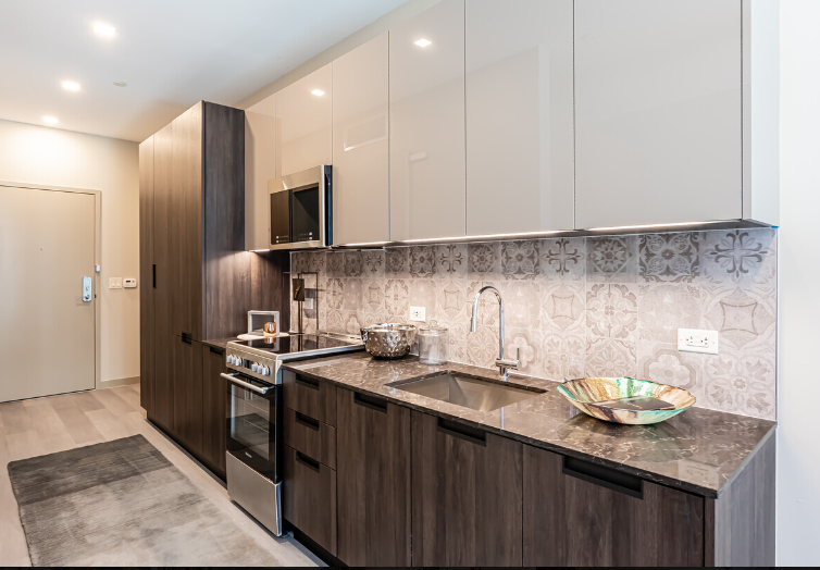 A kitchen with stainless steel appliances and wooden cabinets.