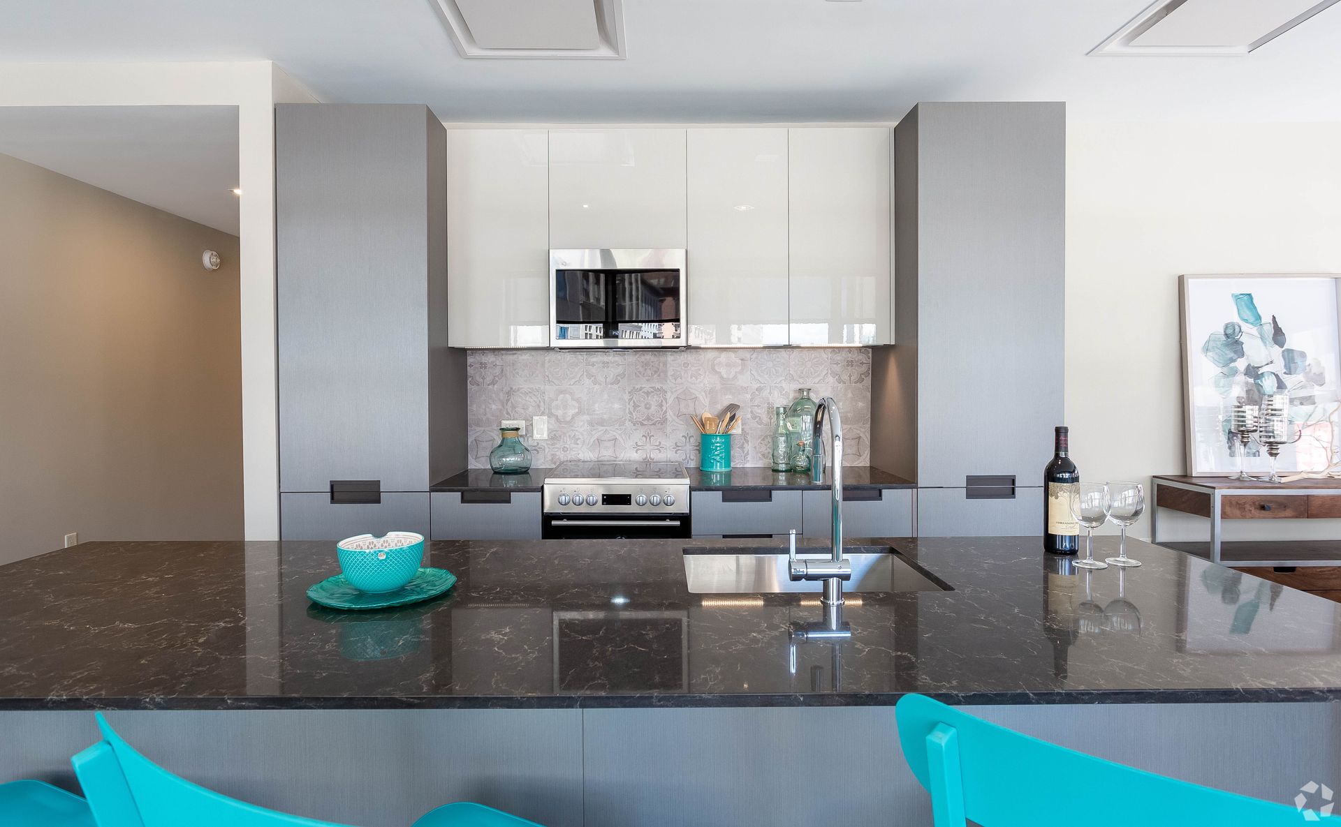 A kitchen with a bottle of wine on the counter