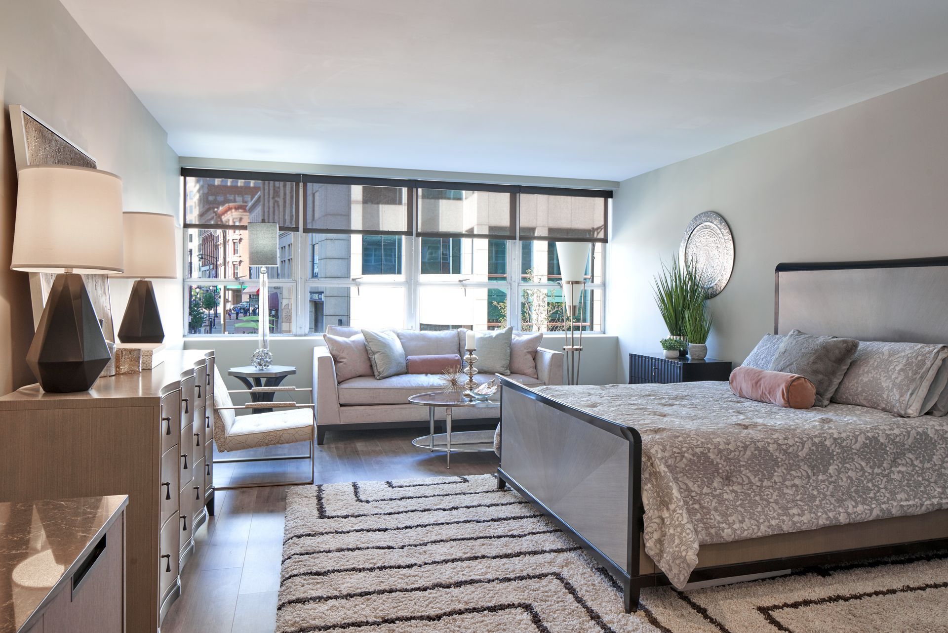 A bedroom with a large bed and a couch