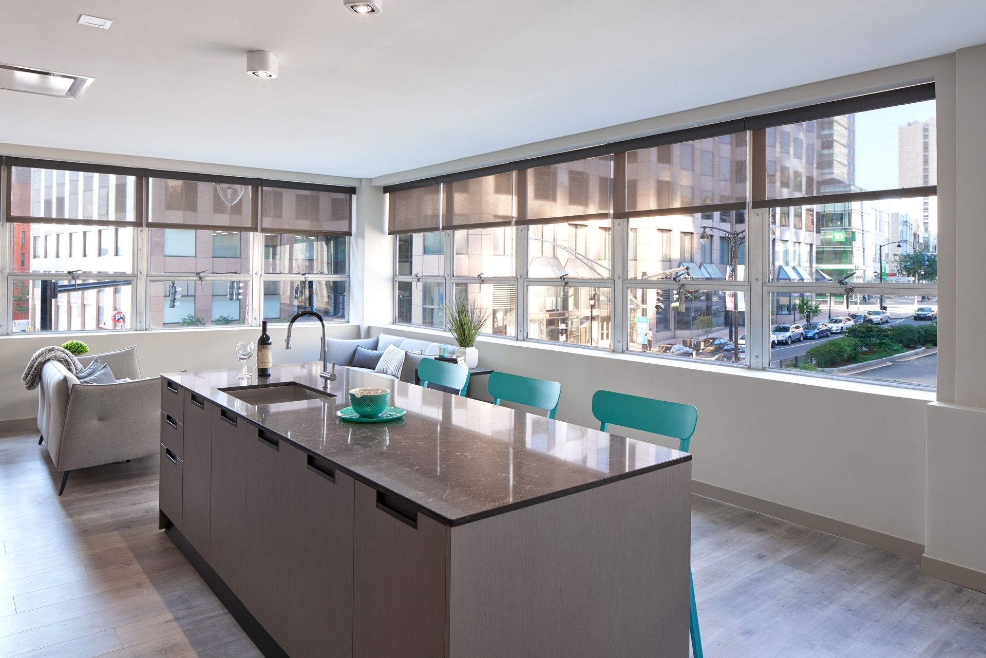 A kitchen with a large island and a lot of windows