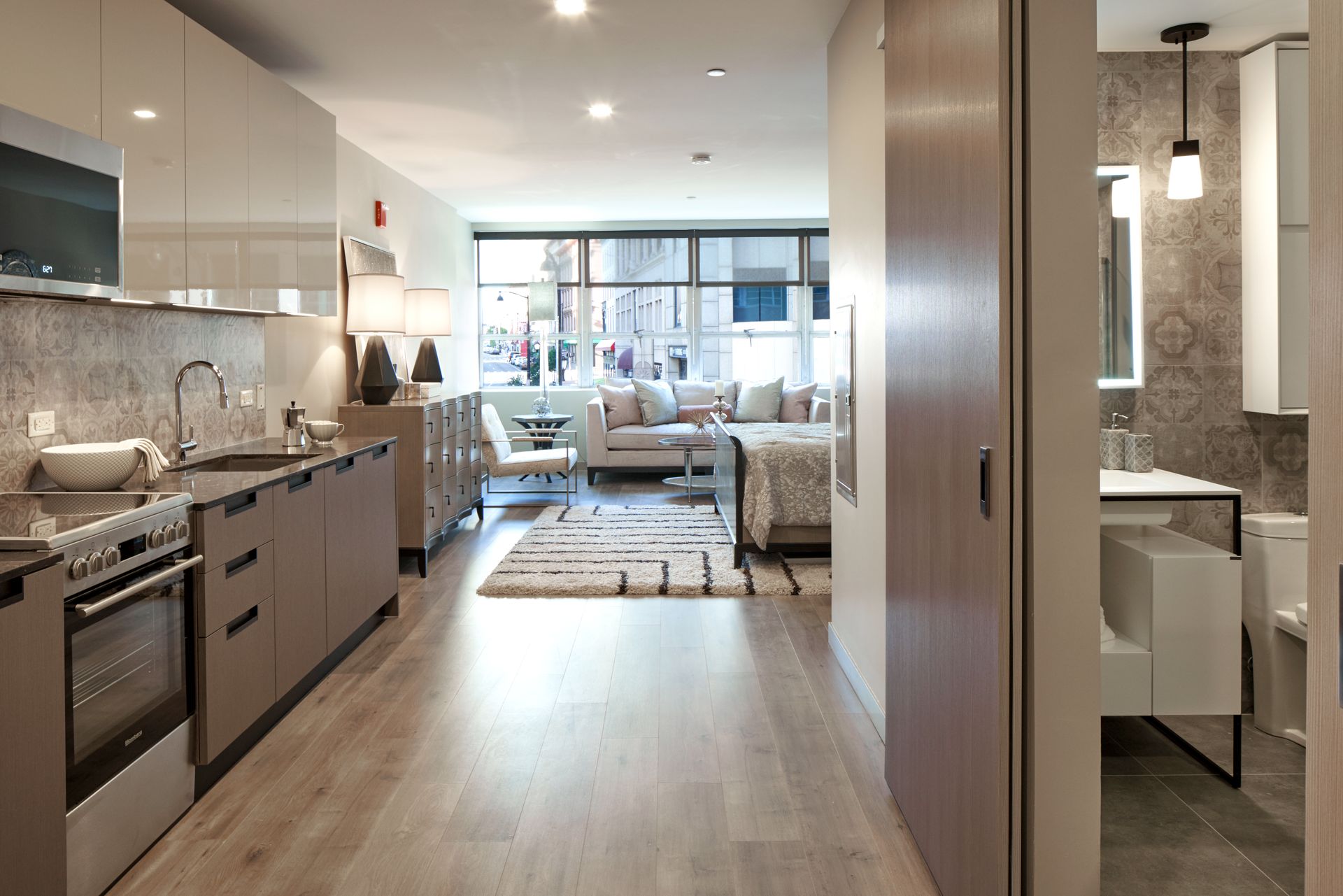 A kitchen with stainless steel appliances and wooden floors