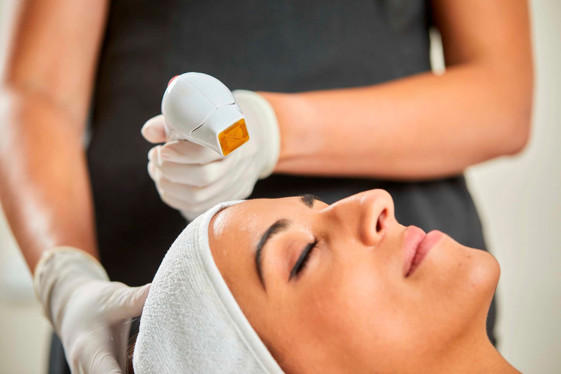 Beautiful Woman Having a Facial Cosmetic Scrub Treatment — Bersantai Medispa in Toukley, NSW