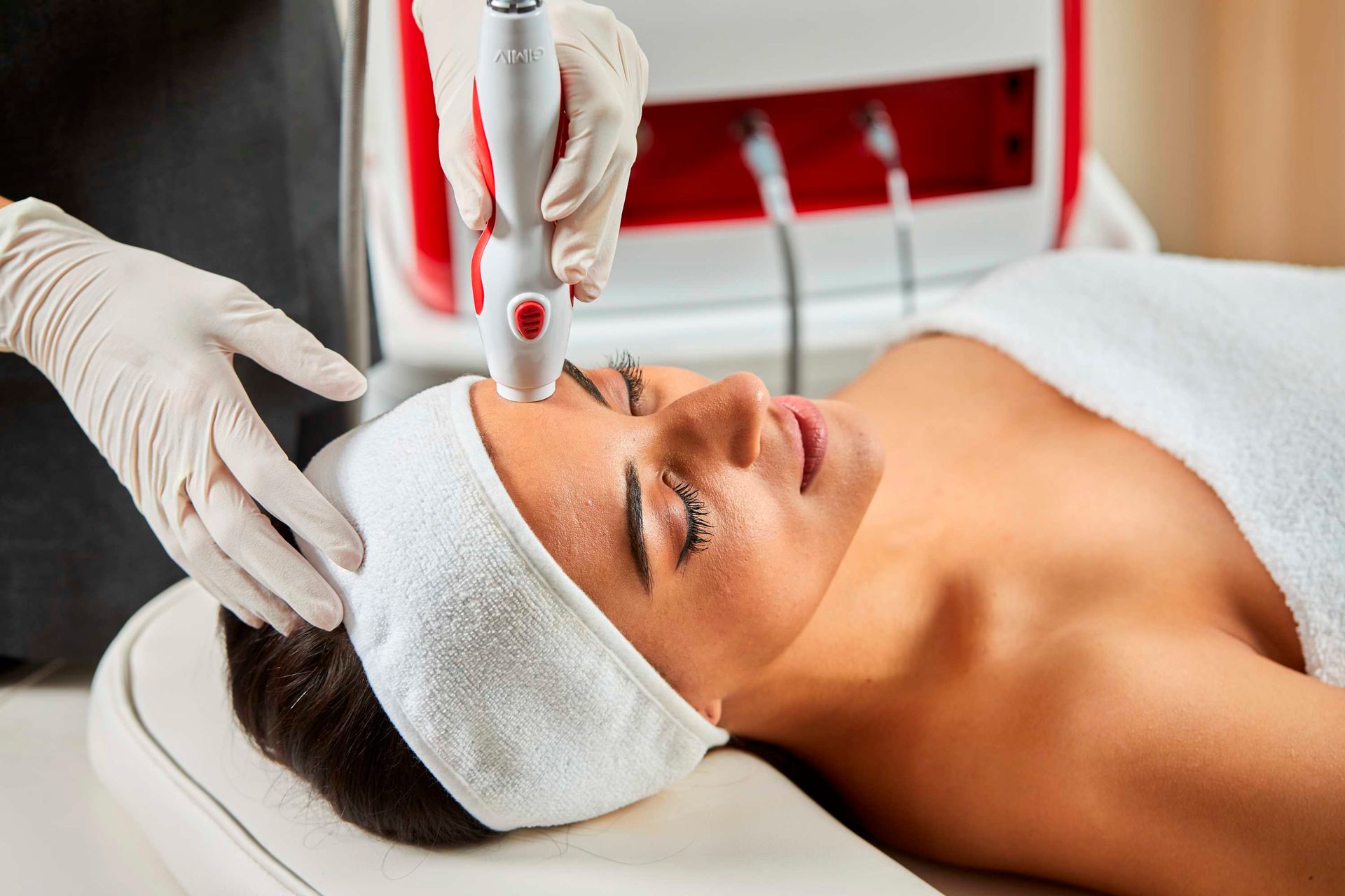 A Woman is Getting a Cavitation Treatment on her Stomach — Bersantai Medispa in Toukley, NSW