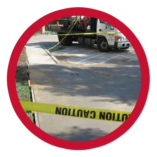 Truck behind caution tape in parking lot, likely involved in maintenance or repair work.