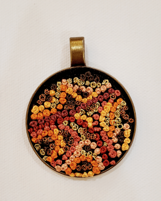 A pendant with a lot of beads on it