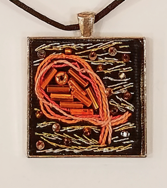 A necklace with a square pendant with beads on it
