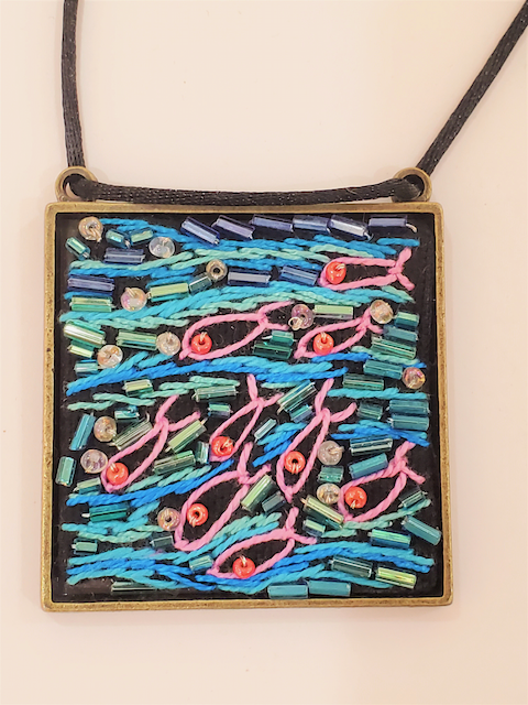 A necklace with a picture of fish on it