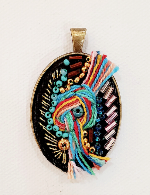 A pendant with a colorful design on it