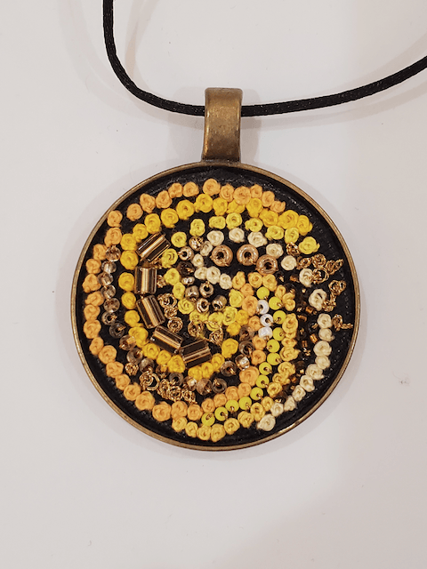 A necklace with yellow beads and nuts on it