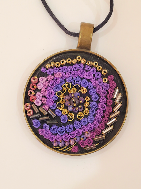A necklace with purple and yellow beads on it