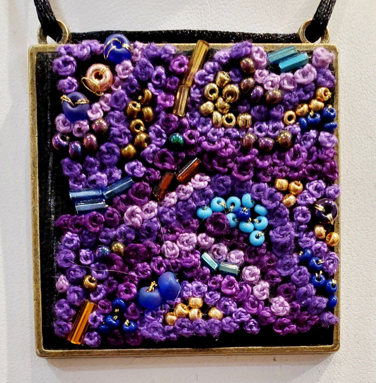 A necklace with purple and blue beads on it