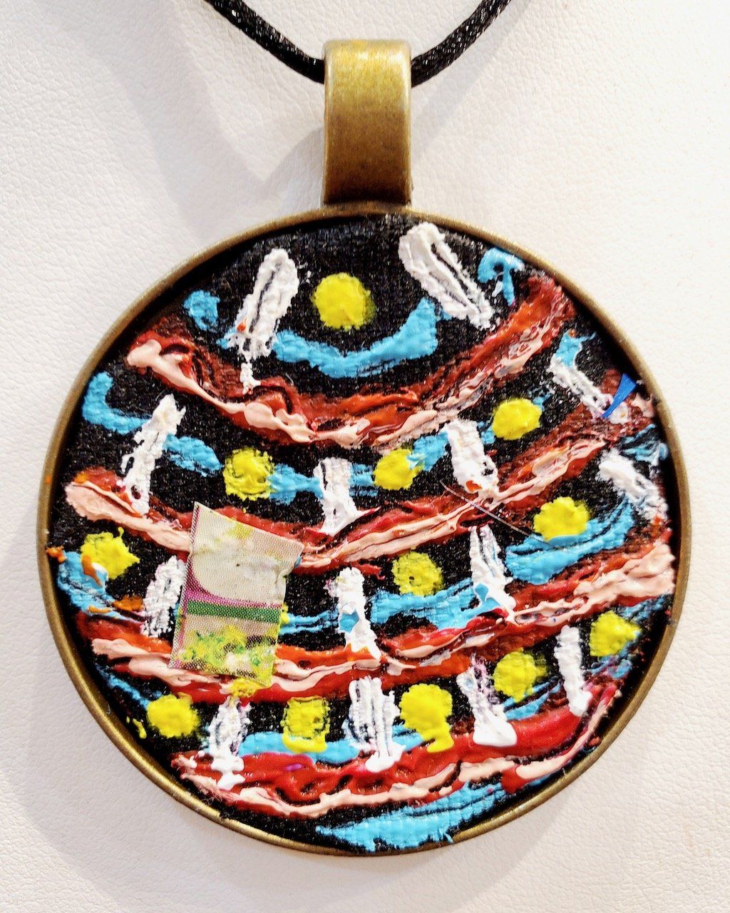 A pendant with a colorful design on it