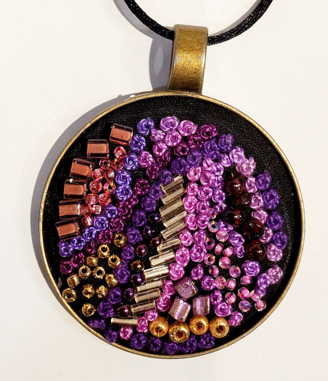 A necklace with purple and pink beads on it