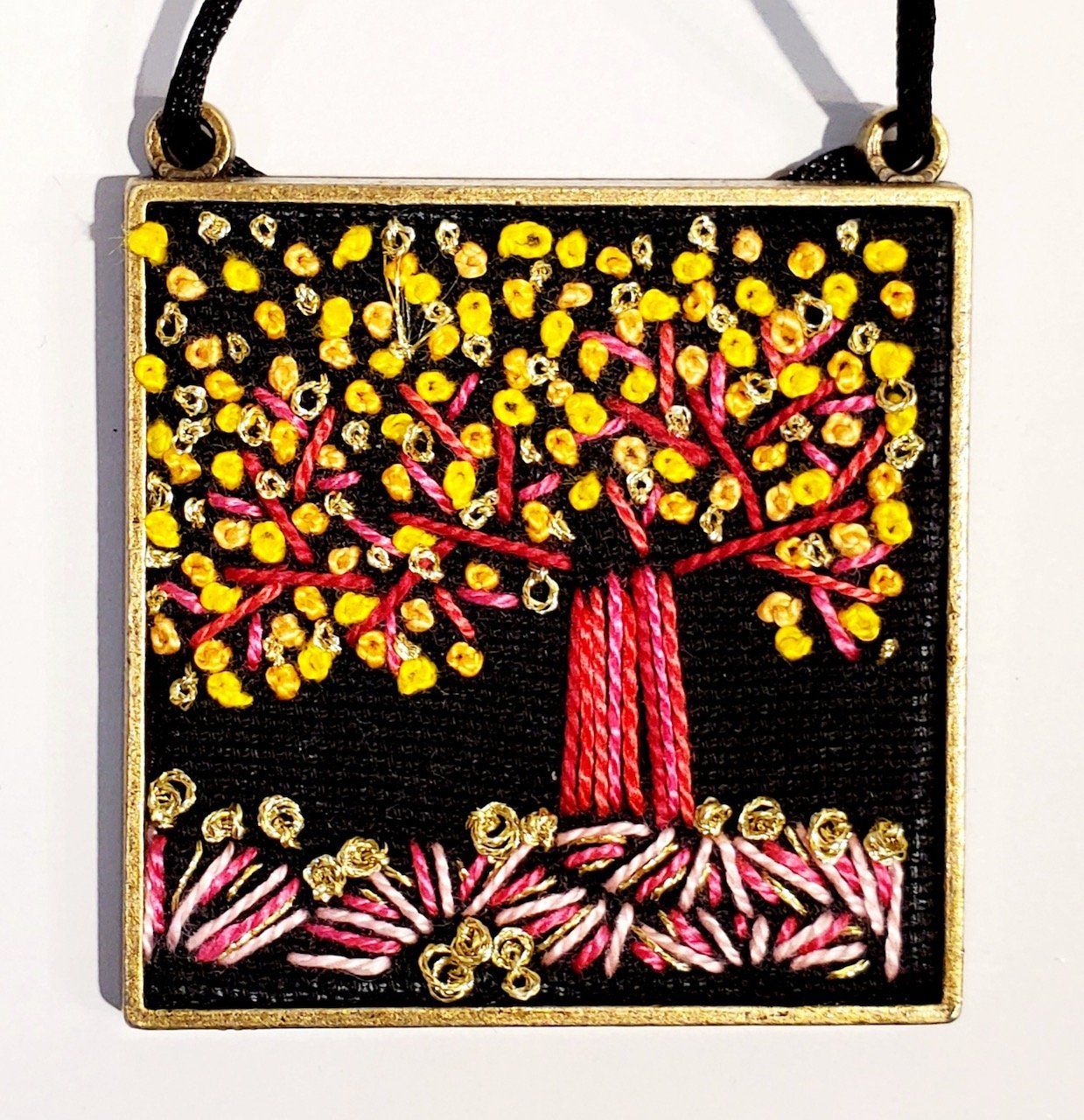 A picture of a tree with yellow flowers on a black background