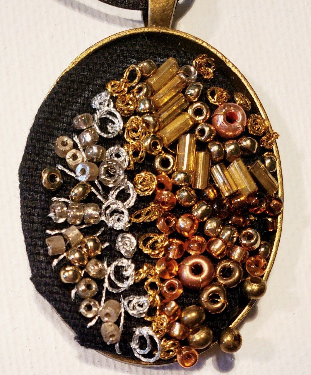 A pendant with a lot of beads on it