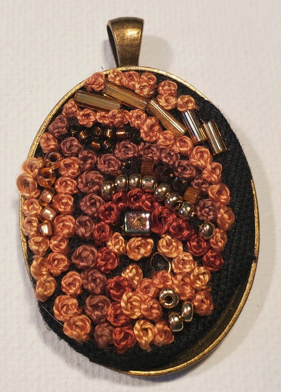 A pendant with a lot of beads on it