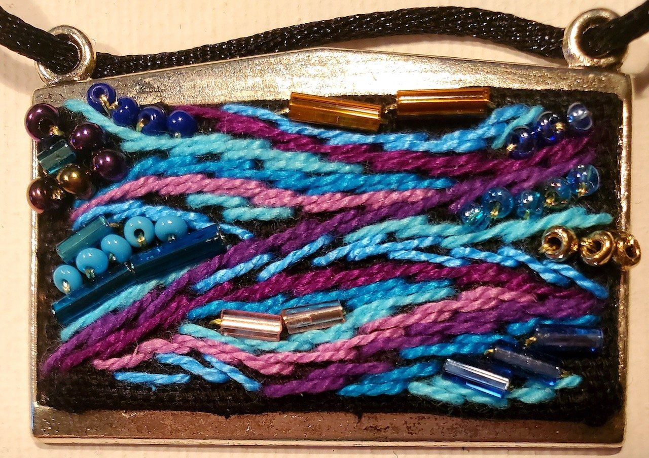 A necklace with purple and blue beads on it