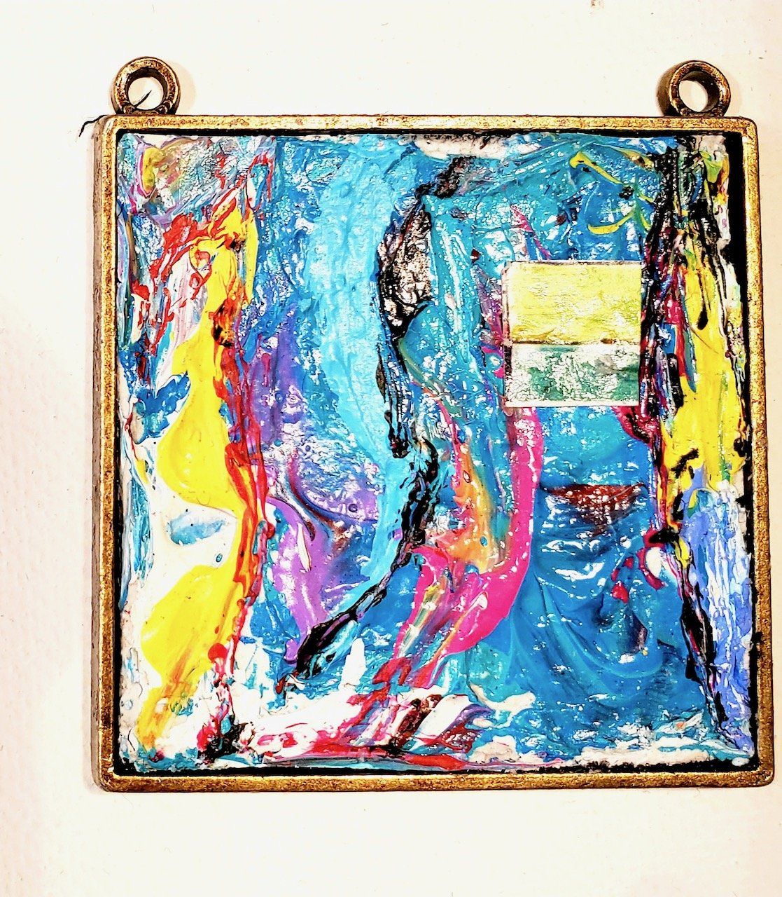 A colorful painting is hanging on a white wall