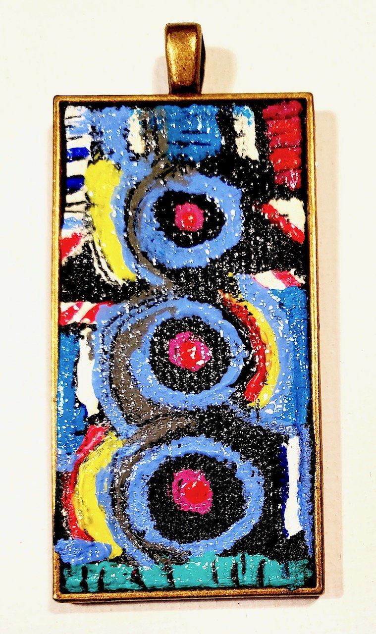 A pendant with a colorful design on it