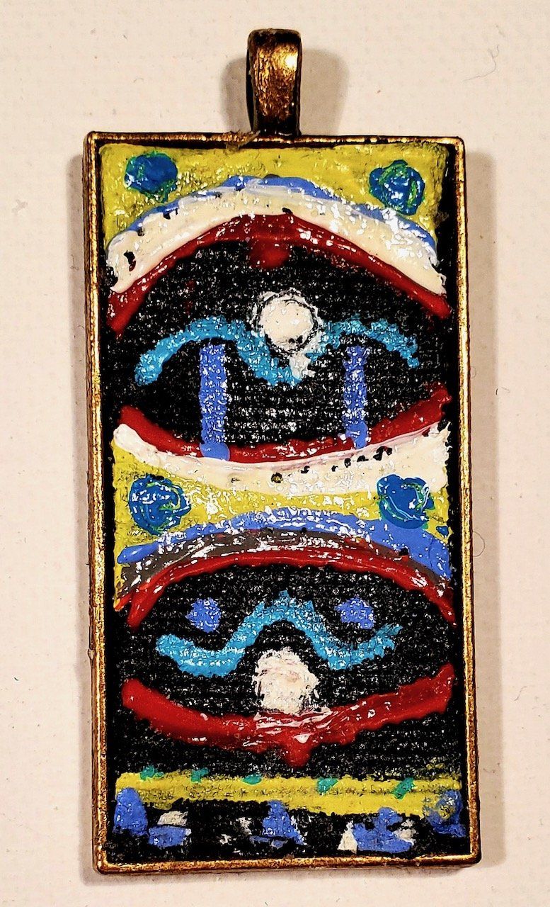A pendant with a colorful design on it