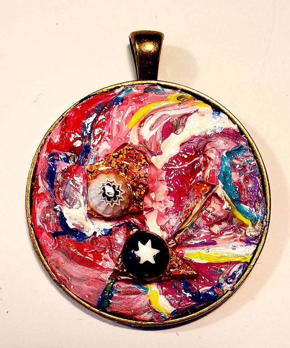 A colorful pendant with a star on it