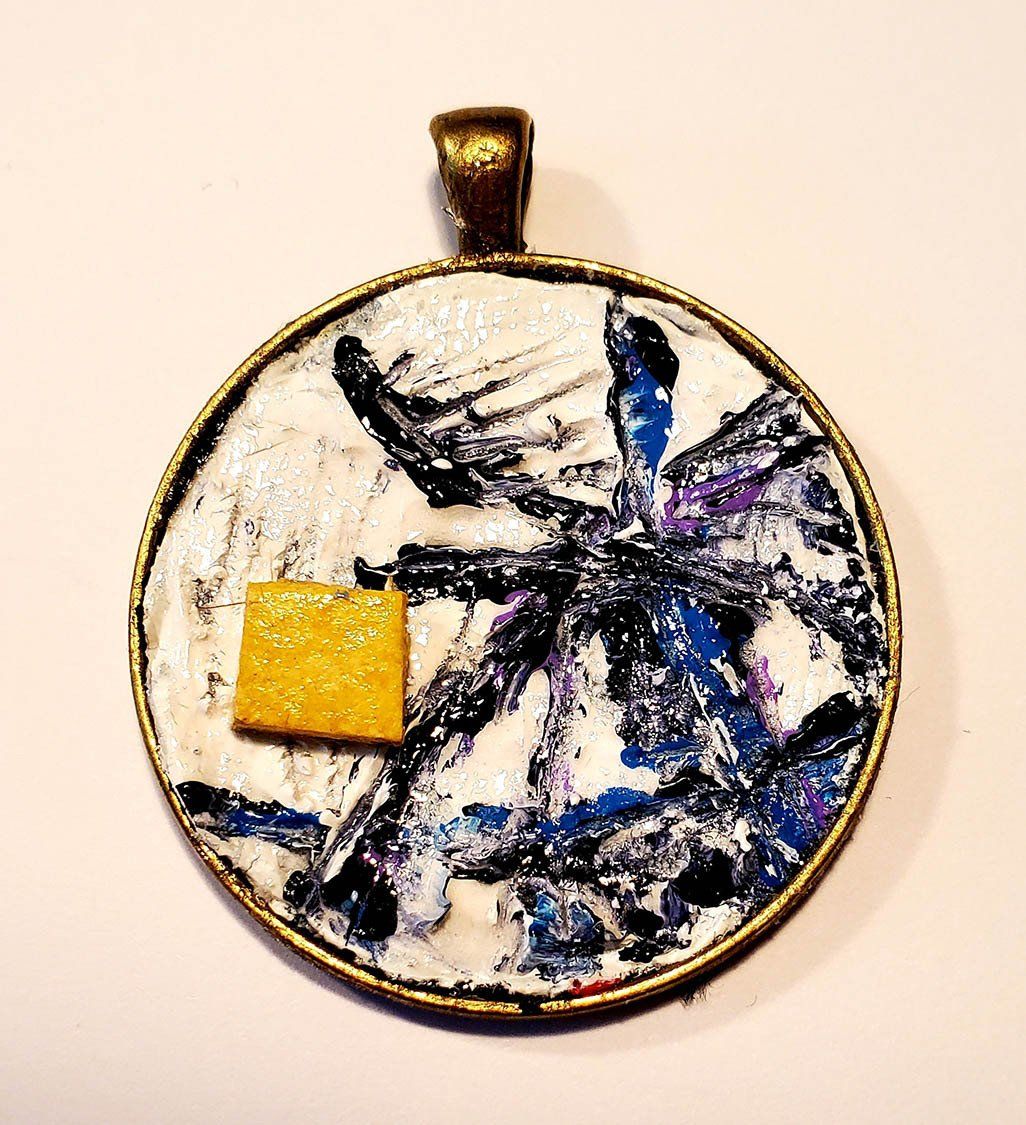 A round pendant with a yellow square in the middle