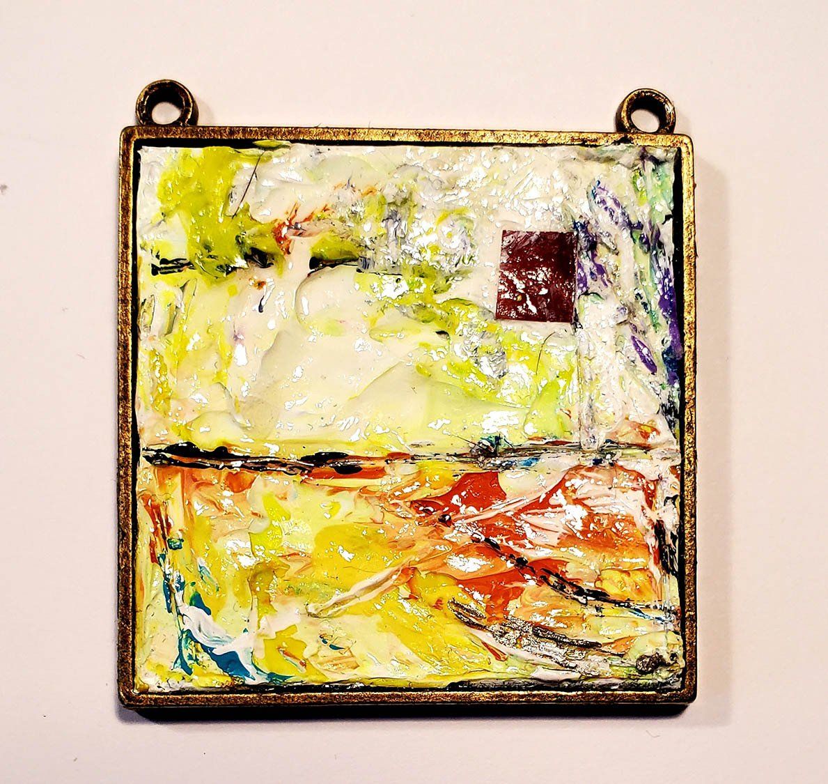 A colorful painting is hanging on a white wall