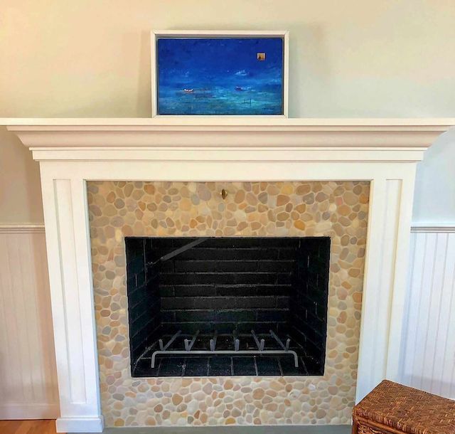 A fireplace with a painting above it in a living room.