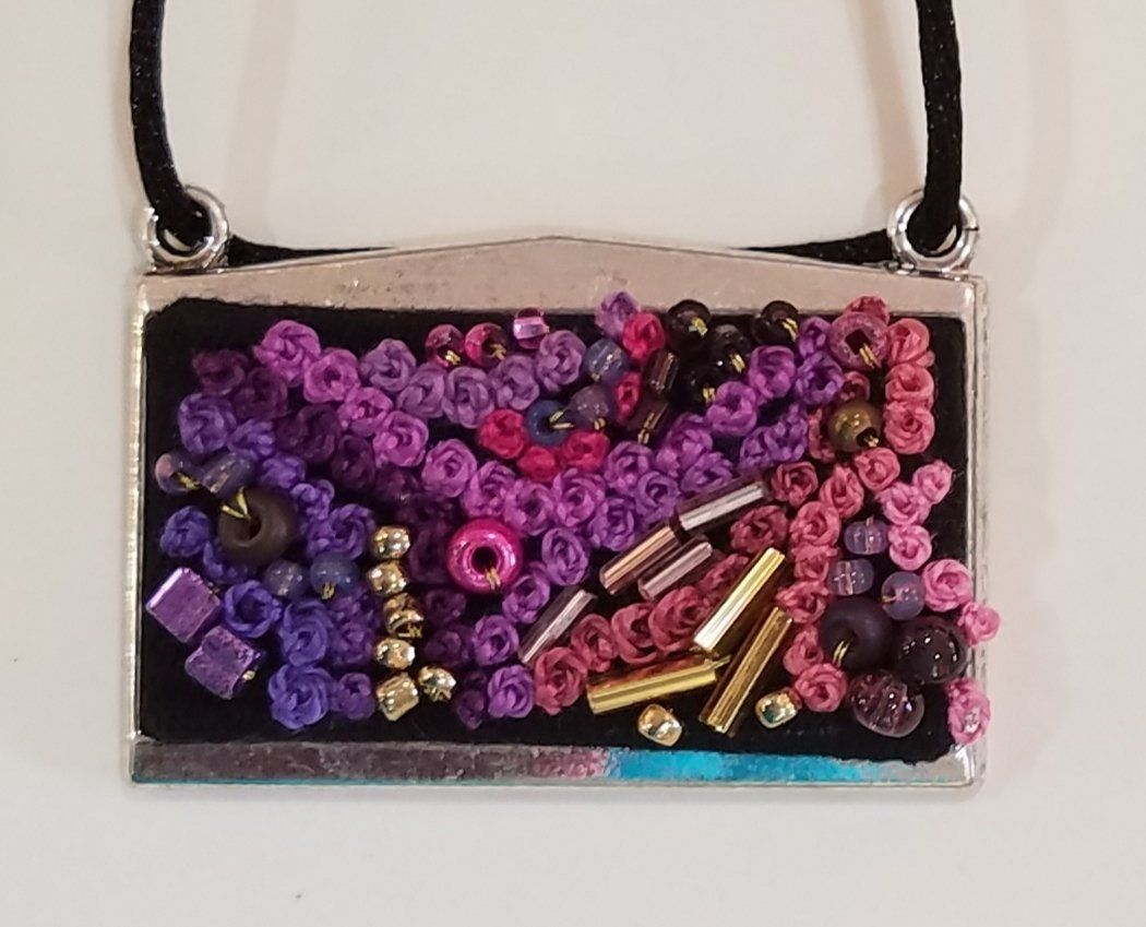 A necklace with purple and pink beads on it