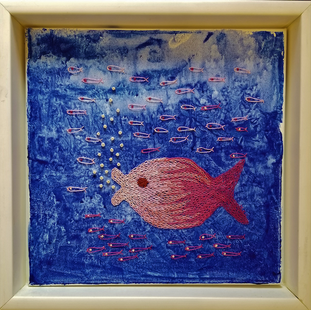 A framed painting of a pink fish on a blue background
