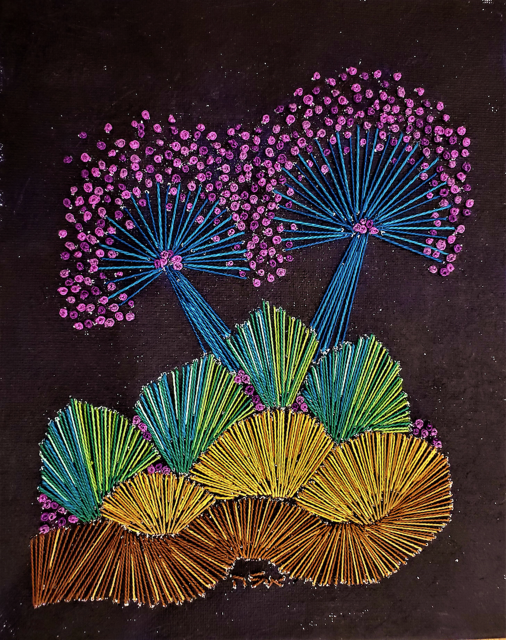 A string art painting of trees with purple flowers