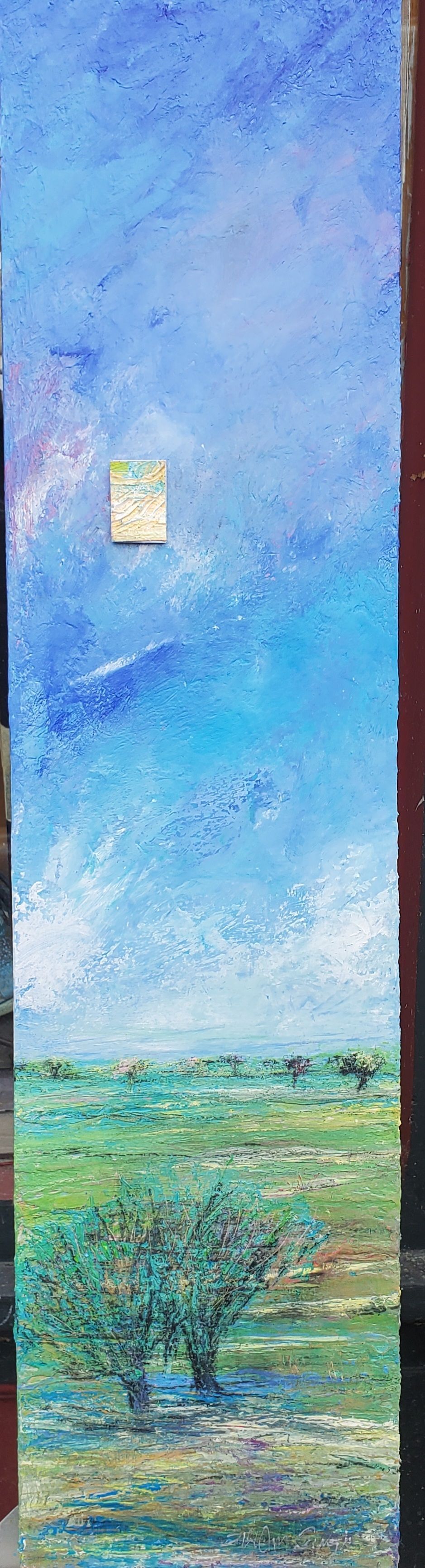 A painting of a field with a blue sky in the background.