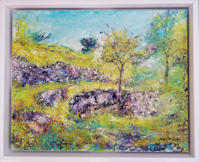 A painting of a landscape with trees and rocks in a frame.