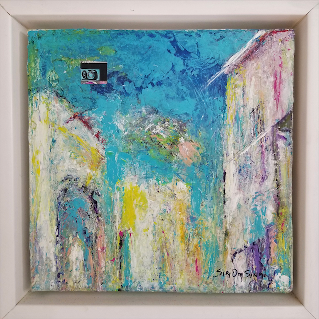 A colorful painting of a building with a blue sky in a frame.