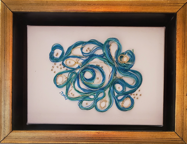 A picture of a peacock in a gold frame