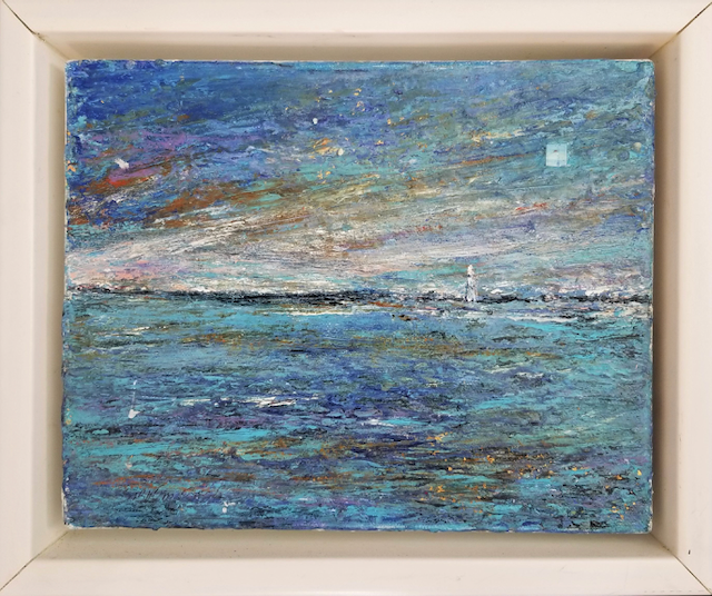 A painting of a sailboat in the ocean in a frame.