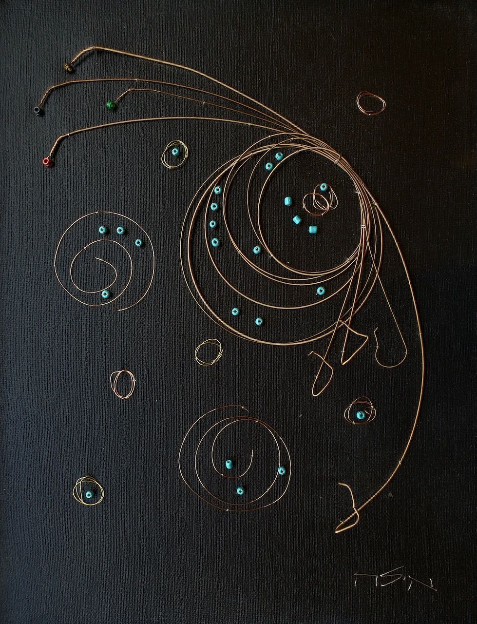 A close up of a embroidered design on a black cloth