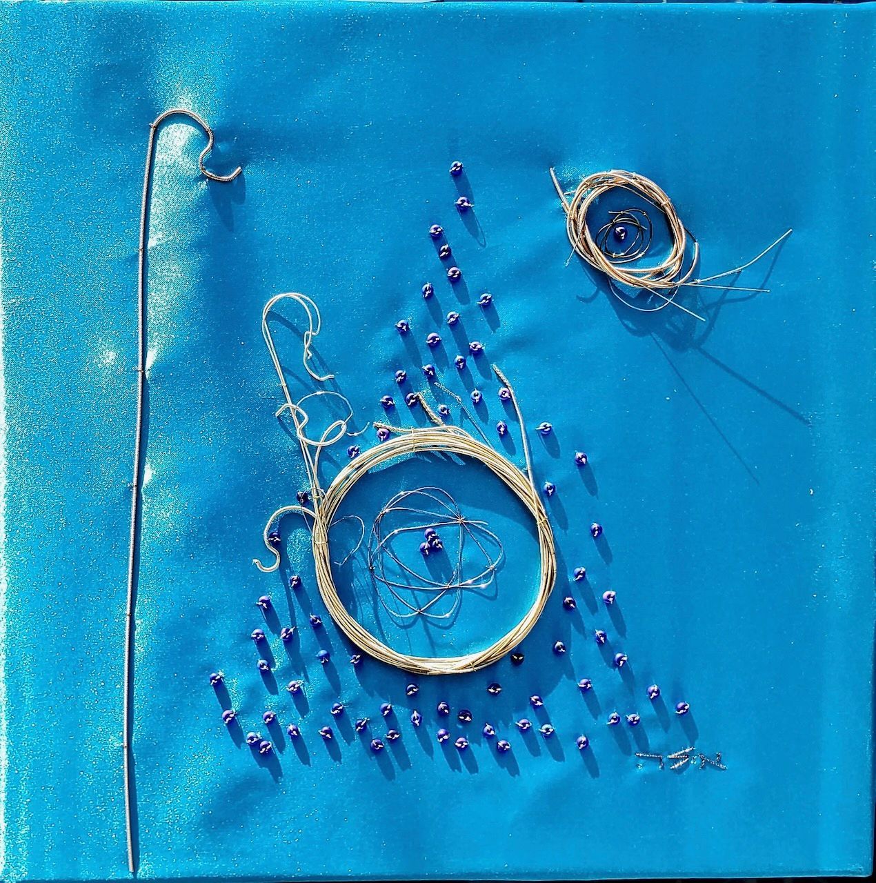 A blue background with a circle and beads on it