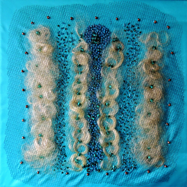 A blue background with a pattern of yarn and beads